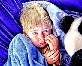 picture of a kid with a blanket who could benefit from a charity donation